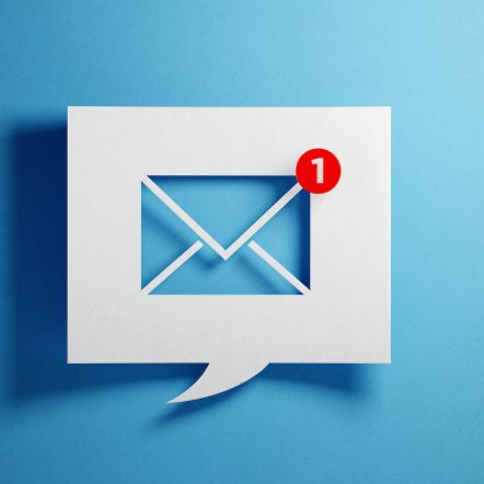 White Chat Bubble With Email Symbol On Blue Background