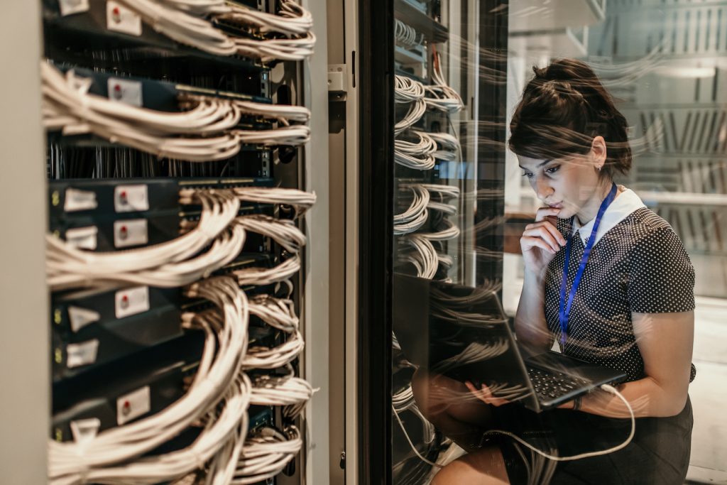 Female IT Engineer Working in Server Room