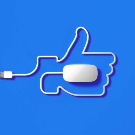 White Mouse Cable Forming A Thumbs Up Symbol On Blue Background