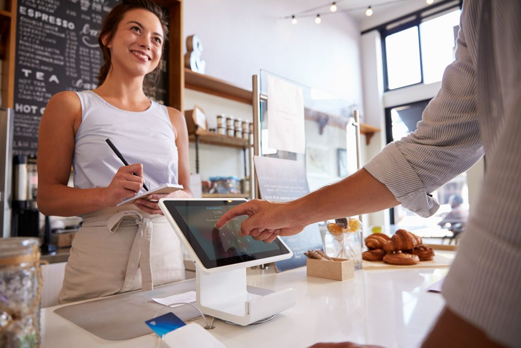 Woman in bakery ringing someone up