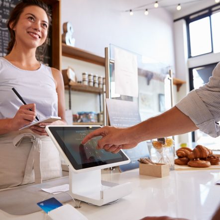 Woman in bakery ringing someone up