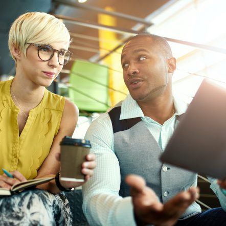 Two creative millenial small business owners working on social media