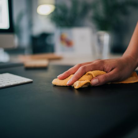 Cleaning desk in the office, close-up.