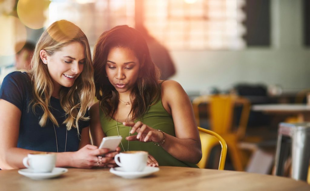 Two women looking at their phone