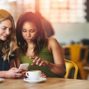 Two women looking at their phone