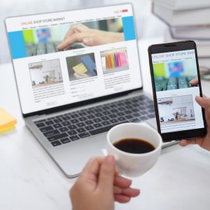 Person looking at their website on a phone and laptop